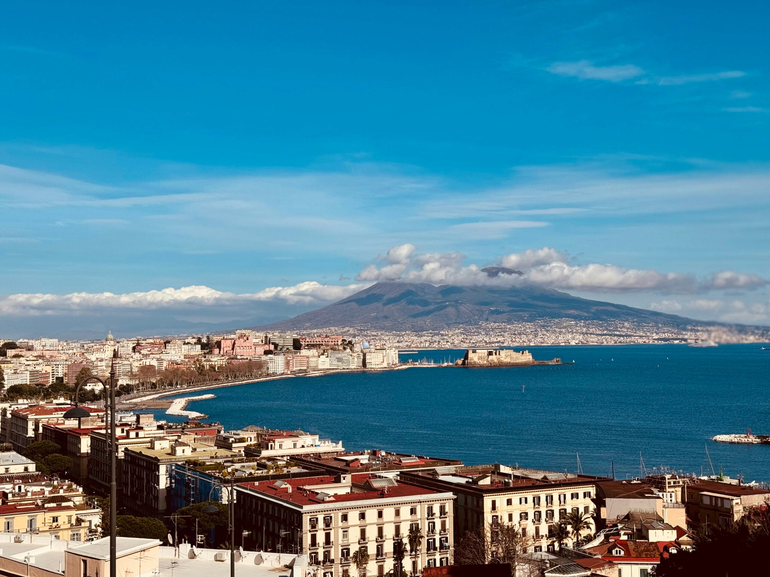 Naples waterfront with Mount Vesuvius and the Bay of Naples at sunset
