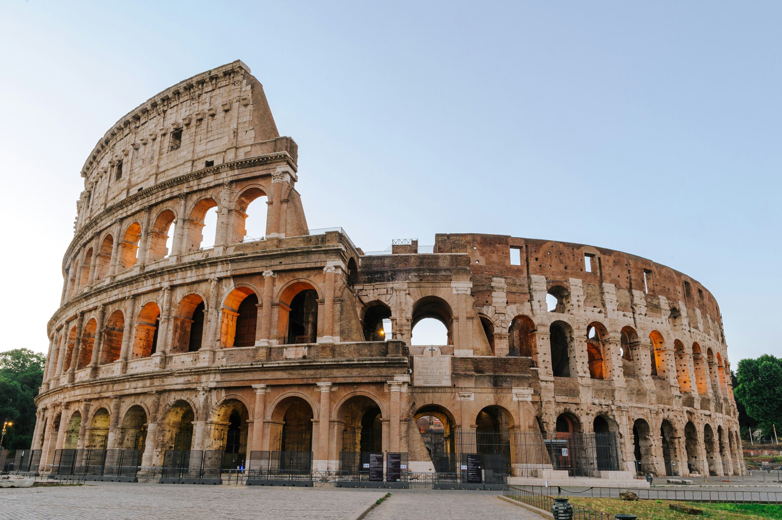 Colosseum in Rome under blue sky with ancient Roman architecture
